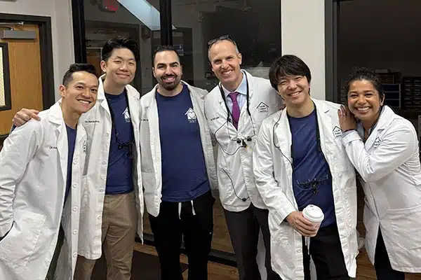 group-photo-of-staff-smiling-at-the-office